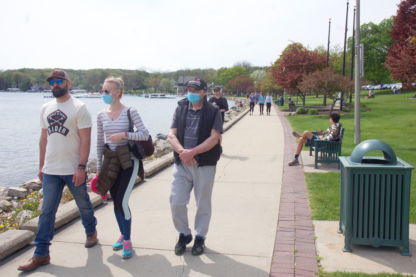 Visitors wear face masks in Library Park in Lake Geneva